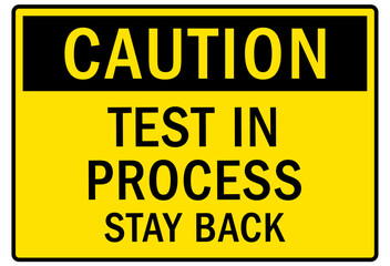 Testing in progress warning sign and labels test in process stay back