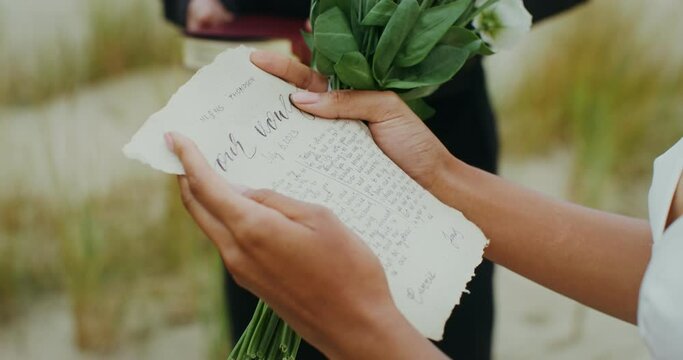 A sheet with a wedding vow in the bride's hands at an outdoor wedding