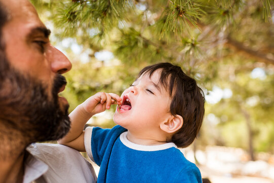 Candid portrait of baby tasting new things with father