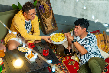 Diversity Asian millennial people friends enjoy dinner party with eating snack potato chip and soft...