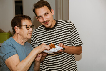 Grandmother and Grandson Indulging in Traditional Mimouna Sweets.