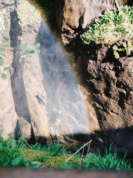 a vibrant rainbow emerges from the splashes created by invisible water