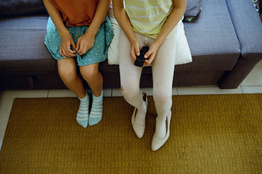 Kids' legs sitting on the sofa