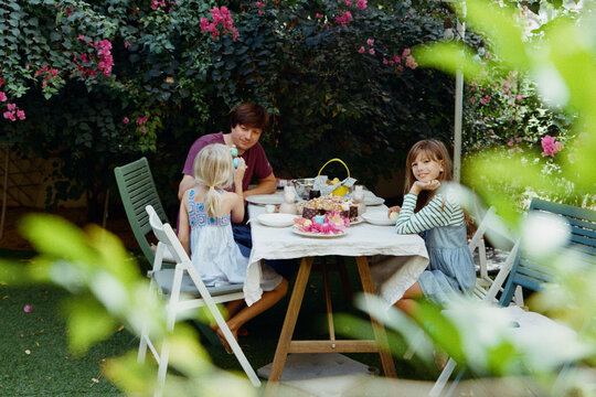 Father with daughters in the garden on Easter