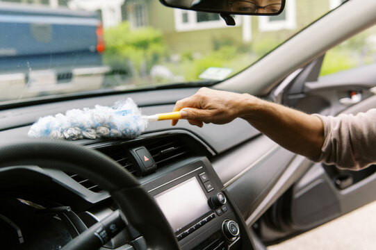 middle aged woman cleaning the interior of her car