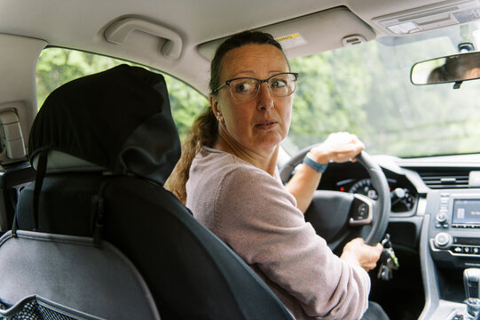 middle aged woman inside a car