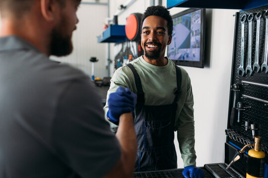 Two Workers in Car Garage 