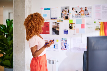 Businesswoman at vision board.
