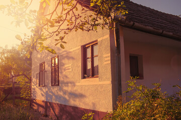 Facade of old peasant house in autumn season.