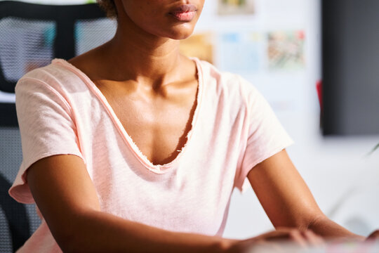 Crop of working woman in sunlight.
