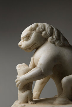 Closeup stone lion carved from white marble, decoration at home