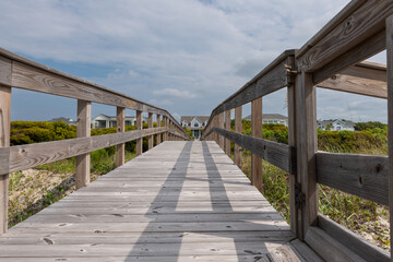 Fototapeta premium Wooden boardwalk from the beach to vacation home.