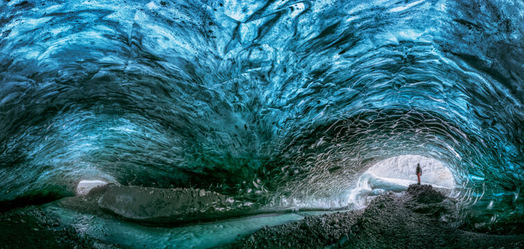 Man exploring an Amazing Glacial Cave in Iceland