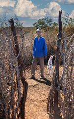 African goat herder in the village, Kraal is an enclosure that is used to keep livestock safe