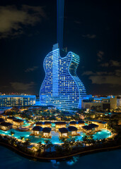 Aerial view of guitar shaped Seminole Hard Rock Hotel and Casino structure illuminated with bright...