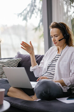 Work from home. Modern technology. Casual clothes. Cozy furniture
