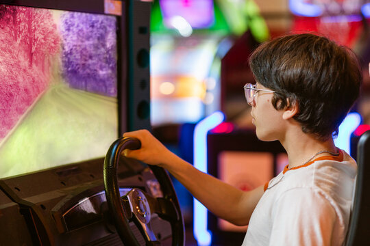 Teenager Plays On Gaming Machine Simulators Car