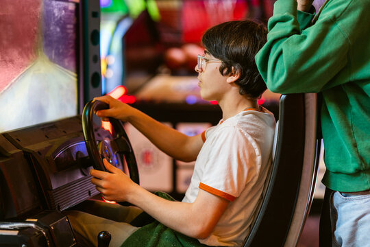Teenager Plays Gaming Machine Simulators Car