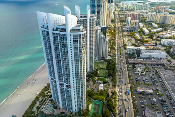 Expensive highrise hotels and condos on Atlantic ocean shore in Sunny Isles Beach city and busy...