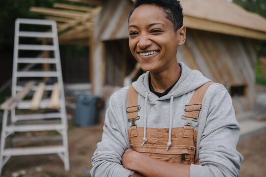 Candid laughing portrait of female carpenter on the jobsite.