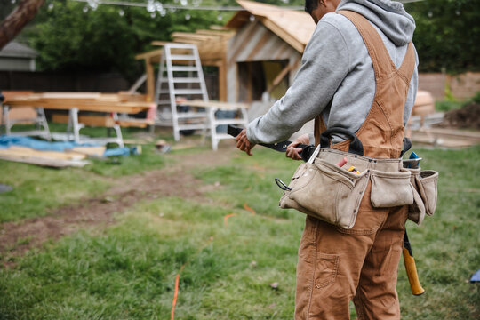 Capenter putting on her toolbelt before work