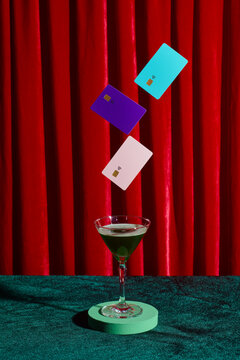 mockup bank credit cards floating on a glass of martini on the table