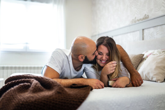 couple in love on the bed in their room