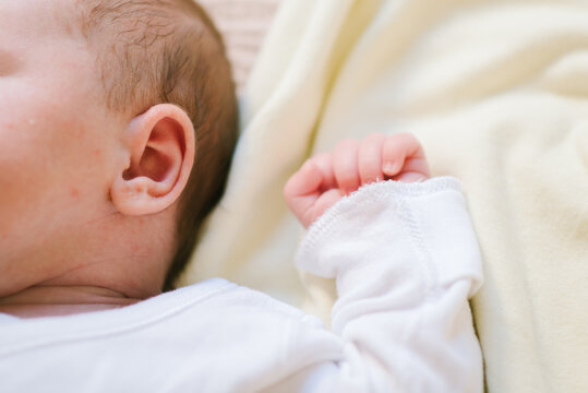 Close-Up of Sleeping Newborn Baby with Arms Thrown Back.