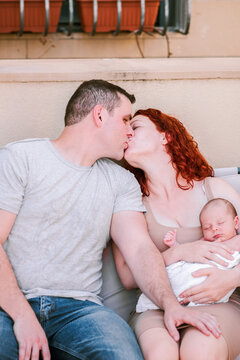 Newly-Made Parents Celebrate Their Love with a Tender Kiss.