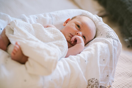 Baby, Covered with a Tetra Diaper, Falls Asleep in His Cradle.