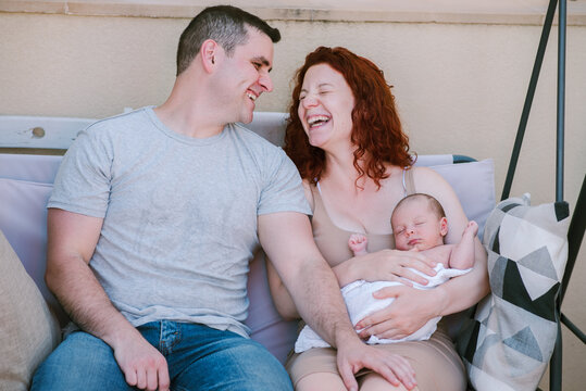 Young Parents with Newborn, Conversations and Laughter in the Patio.