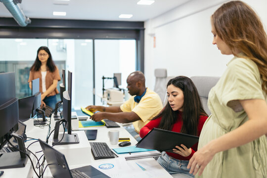Diverse group of workers working with computers in office
