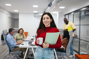 Portrait of a smiling young woman in a modern office