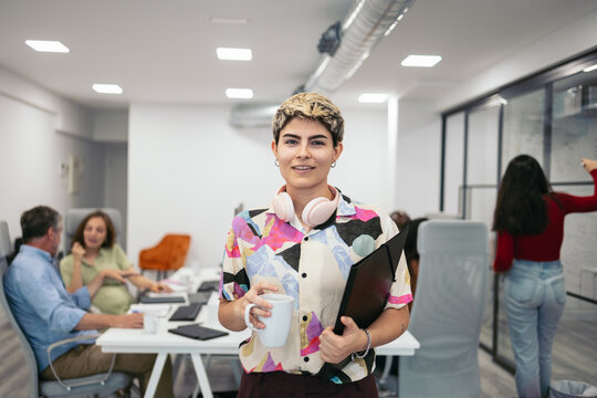 Portrait of a young non-binary person in the office