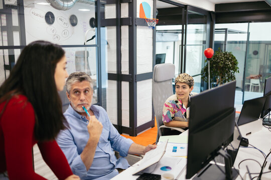 Group of people working with computers in a modern office