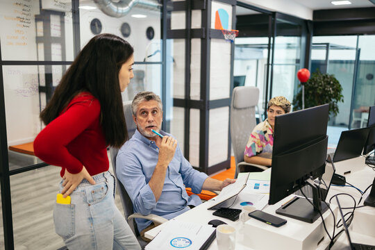 Coworkers reviewing company documents in the office