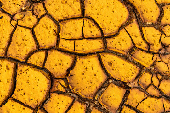 Cracked surface of dry ground in sunlight