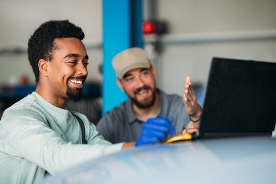 Men Working in Garage, Using Laptop for Diagnostic 
