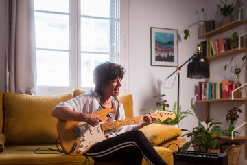 Singing and playing guitar with joy at home