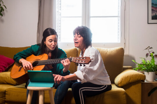 Mother and daughter learning new songs together