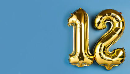 Banner with number 12 golden balloon with copy space. Twelve years anniversary celebration concept...
