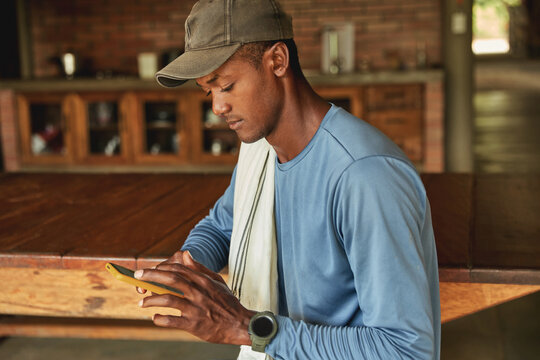 A young Colombian farmer is texting on his mobile phone.