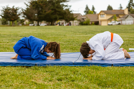 Teenagers bow greeting before judo practice - Powered by Adobe