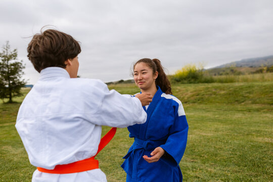 Teenagers practicing judo in park
