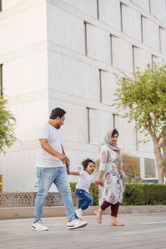 Happy family walking on street