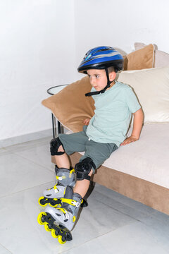 Young Boy Getting Ready First Rollerblades Training with Safety Gear.
