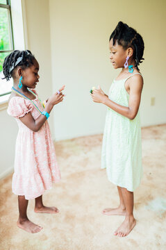 Sisters playing dress up in their room
