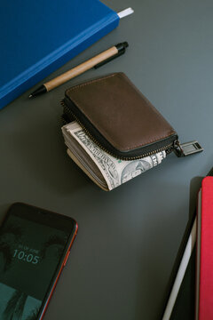 A wad of cash dollars inside the wallet at payday. 