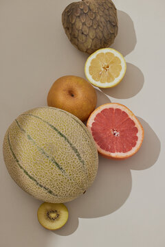 tropical citrus and melon fruits in sunny warm light