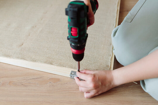 Woman using an electric screwdriver